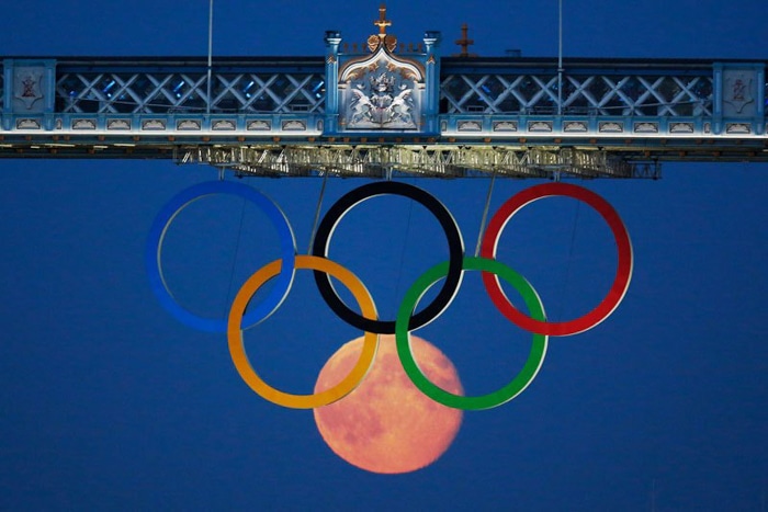 Foto de los anillos olímpicos y la luna debajo de ellos.