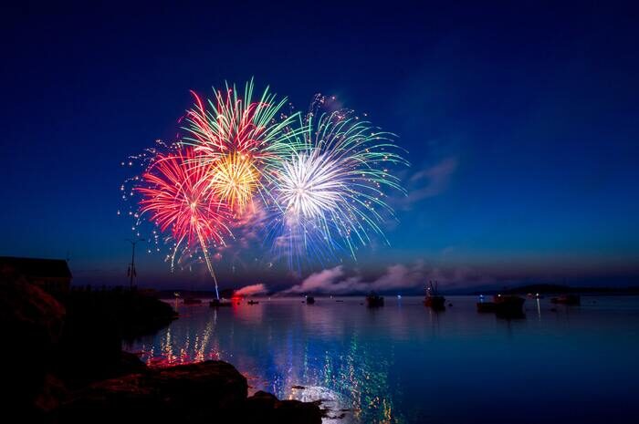 Foto de coloridos fuegos artificiales sobre un río