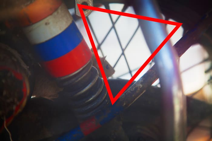 Foto de cerca de piezas de maquinaria con diagrama de triángulo rojo.  Fotografía de encuadre natural.