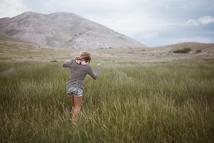 Retrato de una niña caminando frente a un hermoso paisaje