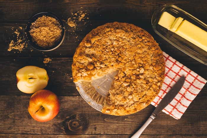 Fotografía cenital de tarta de manzana sobre una mesa de madera