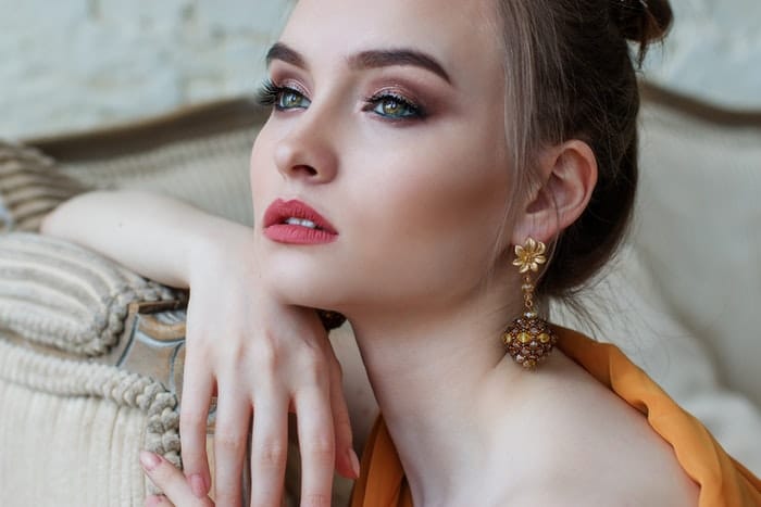 A girl modelling gold earrings