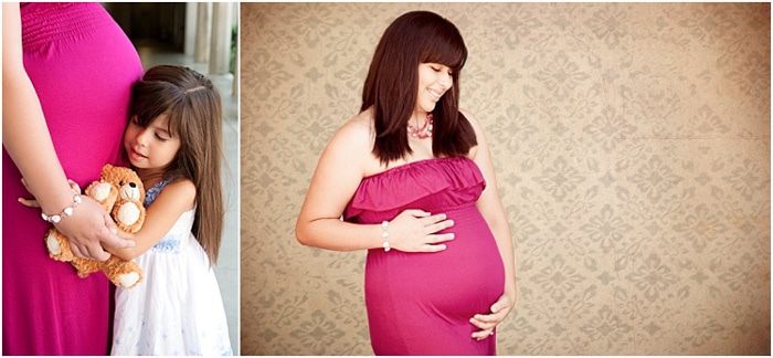 sesión de fotos de maternidad, mujer embarazada con un vestido rosa, su hija abrazándola alrededor de su vientre