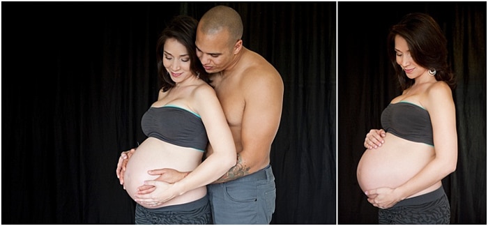 sesión de fotos de maternidad, fondo negro, pareja abrazando su vientre por detrás
