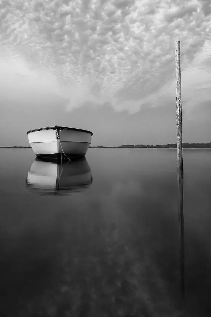 Imagen de un barco en el agua que muestra un buen contraste en blanco y negro