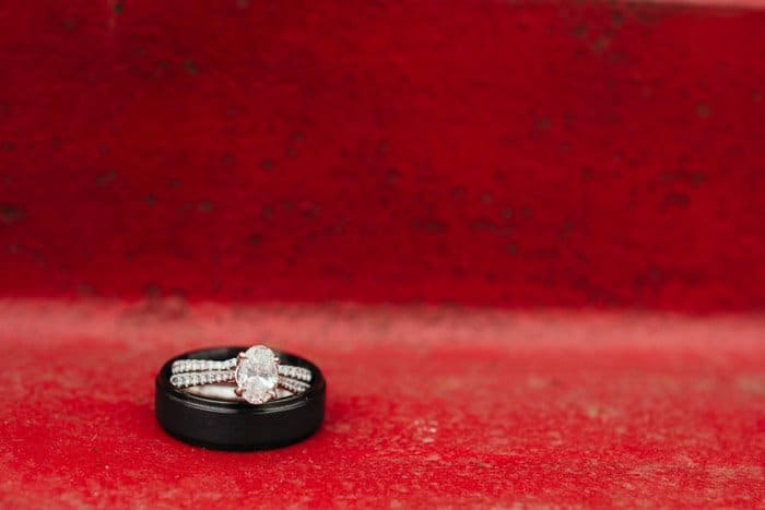 Cerrar foto de dos anillos de boda sobre fondo rojo.