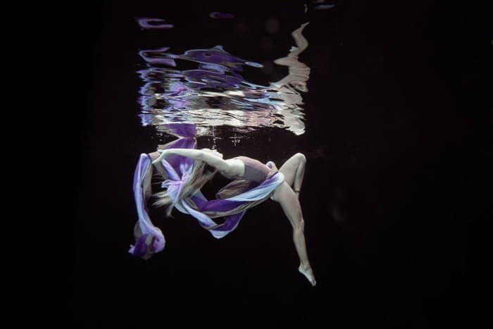 Sesión de fotos submarina atmosférica de una modelo femenina posando bajo el agua