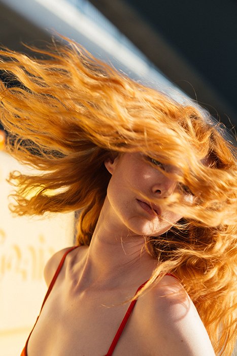 Impresionante retrato de una niña lanzando su cabello castaño rojizo: hermosos principios de fotografía