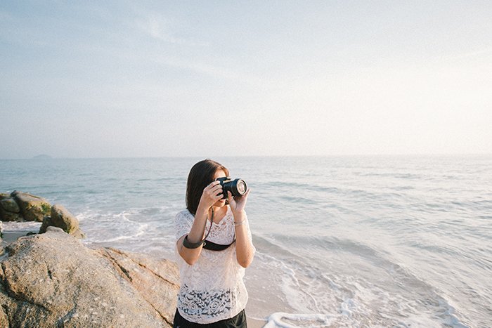 Un ejemplo de fotografía sincera de una mujer que toma fotos en la playa