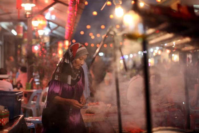 Una foto callejera nocturna de un vendedor ambulante de comida