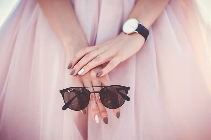 Una foto de moda de una chica en rosa con gafas de sol 