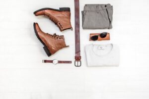 Flat lay product photo of shoes, watch, belt and clothes
