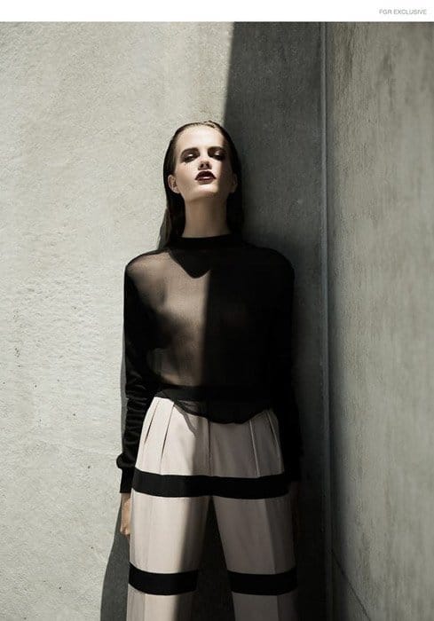 Una imagen llamativa de una modelo femenina posando junto a un muro de piedra: ideas para fotografías de moda