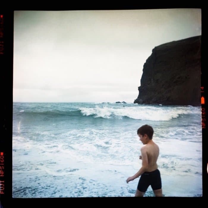 fotografía de un niño en una playa filmada con una película caducada